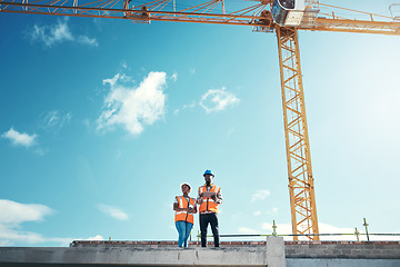 Image showing Building roof, engineer team talking at construction site outdoor for vision, development or architecture. Black woman and man for engineering teamwork, planning or safety discussion with sky mockup