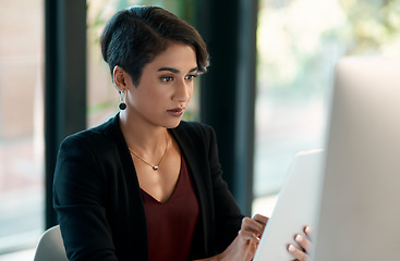 Image showing Tablet, computer and business woman in office for website analysis, online management or technology solution. Review, typing or scroll of professional biracial person on desktop and digital software