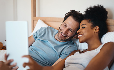 Image showing Happy couple, smile and relax on bed for selfie, photo or morning post together at home. Interracial man and woman person smiling for fun profile picture, memory or vlog in bedroom at the house