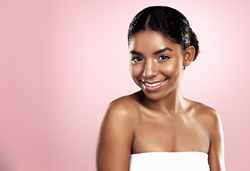 Image showing Portrait, happy woman and face for skincare on pink background, studio and mockup for clean dermatology. African, female model and natural beauty with confidence, glowing skin and aesthetic cosmetics