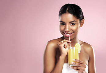 Image showing Portrait, happy woman and orange juice drink in studio for healthy skincare, vitamin c benefits or mockup. African model, fruit cocktail and citrus smoothie of natural beauty, diet or pink background