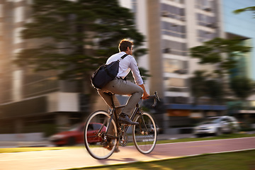 Image showing Fast, bicycle and business man in city for morning, commute and carbon neutral transportation. Travel, sustainability and cycling with male employee in urban town for motion blur, speed and transit