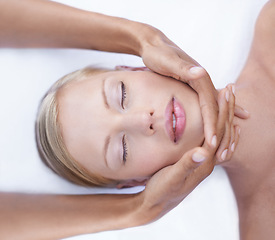 Image showing Relax, facial and massage, woman in spa for health, wellness and luxury treatment with eyes closed. Beauty salon, professional skin care therapist hands and healthy face of girl on table from above.