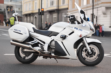 Image showing Police, motorcycle and transportation vehicle in city, safety and law enforcement on urban road, empty street and Norway. Security, motorbike and travel for public service, legal power and authority