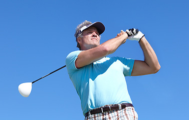 Image showing Golf, swing and elderly man with driver outdoor for training, hobby and sports on blue sky background. Club, swinging and active senior male golfer on field for retirement fitness, match or practice