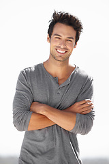 Image showing Smile, portrait and man with arms crossed in nature for break, vacation or weekend in Spain. Happy, fashion and a handsome young guy smiling with confidence, happiness and relaxing on holiday