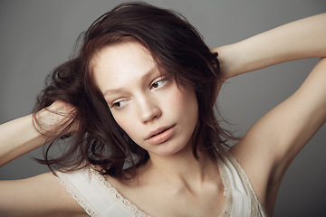 Image showing Sad, thinking and a woman with mental health problem isolated on a dark background in a studio. Idea, depression and a young girl or model with ideas, depressed and thoughts of anxiety on a backdrop