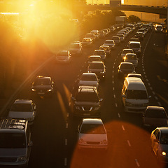 Image showing Traffic jam, sunset and highway with cars in road for transportation, rush hour and travel. Journey, automobile and driving with vehicles in urban city for morning commute, moving and busy street