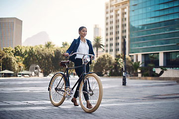 Image showing Travel, city and businesswoman walking with a bicycle in the morning in the street to work. Eco friendly, transport and professional female employee commuting to the office with a bike in urban town.