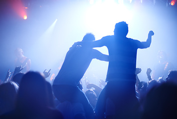 Image showing Rock concert, celebration and party crowd with lighting and people back with dancing. Silhouette, audience and night festival event with performance and group listening and watching a band music