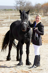 Image showing Horse rider, trainer portrait and woman on equestrian training and competition ground. Outdoor, female competitor and show horses stable with a girl stroking an animal before riding with helmet