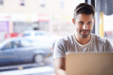 Image showing Entrepreneur, smile and man with a laptop, cafe or typing for information, project or review. Male employee, freelancer or happy worker with connection, technology and search website at a coffee shop