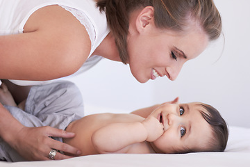 Image showing Mother, happy and baby smile at home on diaper changing table with happiness. Family, house and young child with mom feeling love, care and parent support from bonding together with cute kid and mama