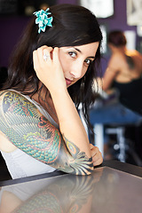 Image showing Creative, tattoo and portrait of woman in parlor for body art, design and creativity in ink shop. Tattoos, artist and face of female person with flower in hair for natural beauty, cosmetics and smile