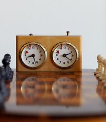 Image showing Chess sport, timer and clock for challenge isolated on a white background mockup in studio. Game, board and countdown for time, alarm and tactical competition for strategy, logic and vintage watch.