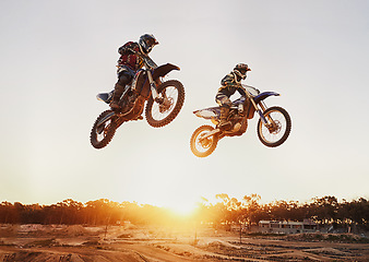 Image showing Motorbike, jump and adventure during race for competition as transportation with sunset. Men, motorcycle and action for sports in the outdoor on fast course with power and moving fast with risk.