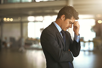 Image showing Headache, stress businessman standing and at his office sad or upset at debt fail at work. Mental health or anxiety, burnout and exhausted or depressed male corporate worker frustrated and tired