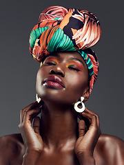 Image showing Beauty, Cosmetic and woman with a turban in studio with a elegant, glam and makeup face. Classy, jewelry and young African female model with a head wrap doing sensual pose isolated by gray background