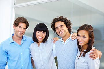 Image showing Business people, portrait smile and hug in teamwork for friendship, team building or success at the office. Happy and confident employees standing together smiling for company goals at workplace