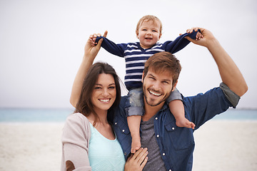 Image showing Family and portrait of baby with parents at a beach for piggyback and walking in nature. Face, kid and happy woman with man outdoors bonding, smile and relax with love, freedom and travel