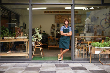 Image showing Happy, arms crossed and portrait of man at restaurant for small business, coffee shop and waiter. Entrepreneur, welcome and smile with male barista at front door of cafe for diner and food industry