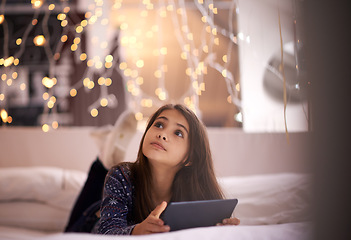 Image showing Thinking, tablet and children with a girl in her home, lying on the living room floor to relax or daydream. Kids, idea and technology with a young female child browsing the internet in her house