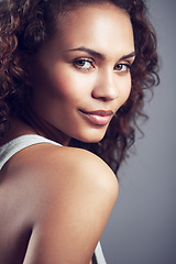 Image showing Smile, attractive and portrait of model woman isolated on a dark background in studio. Stylish, confident and a young lady with happiness, curly hair and looking beautiful on a backdrop for modeling