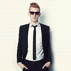 Image showing Fashion, suit and portrait of a man in a studio with sunglasses and a stylish formal outfit.Young, cool and handsome male model with elegant trendy style and confidence isolated by a white background