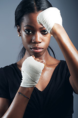 Image showing Portrait, fighting and a woman boxer in studio on a gray background for self defense, fitness or training. Health, exercise and workout with a black female fighter practising for a boxing competition