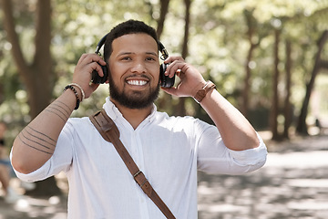 Image showing Happy, portrait and a businessman with music in a park to travel to work in the morning. Smile, young and a male corporate employee listening to a podcast, streaming the radio or audio in nature