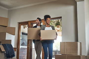 Image showing Happy couple, real estate and boxes in new home for renovation, investment or relocation together. Interracial man and woman real estate owner carrying box in house, move or mortgage for property