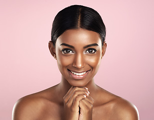 Image showing Face portrait, skincare and smile of woman in studio isolated on a pink background. Natural beauty, aesthetic and Indian female model with makeup, cosmetics and spa facial treatment for healthy skin.