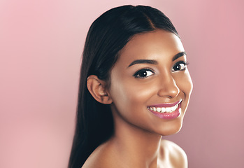 Image showing Face portrait, skincare and happy woman in studio isolated on a pink background mockup space. Natural, beauty and Indian female model with makeup, cosmetics and spa facial treatment for healthy skin.