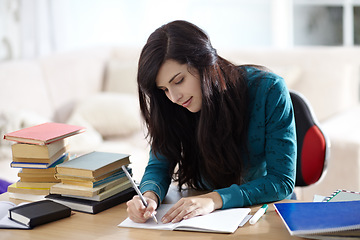 Image showing Books, education and girl writing in book for learning, assignment or homework in her home. Student, female and notebook at table for project, planning and brainstorming, creative and idea notes