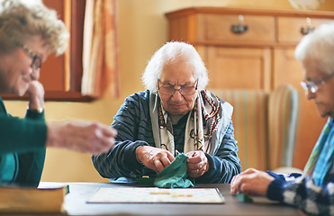 Image showing Senior women, board game and nursing home friendship or old people, thinking and play games together in retirement. Elderly group, entertainment or hobby, retired friends and assisted living activity