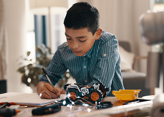 Image showing Learning, writing in notebook and kid with robotics homework, homeschool and science for tech project. Taking notes, car robot and boy child with knowledge, education and studying in house alone.