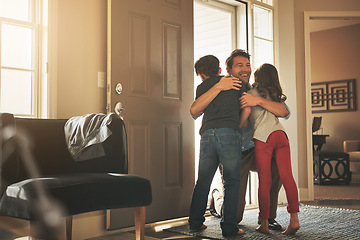 Image showing Home, love and a father hugging his kids after arriving through the front door after work during the day. Greeting, family or children with a man holding his son and daughter in the living room