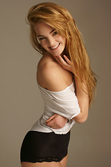 Image showing Ginger, smile and portrait of woman in studio in underwear for playful flirting, seductive and confidence. Beauty, happiness and face of isolated beautiful woman on beige background for sexy attitude