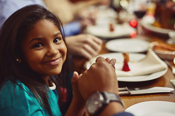 Image showing Portrait, meal and girl with her family, prayer and happiness with joy, home or religious. Face, young person or female child holding hands, praying and worship for blessing, food or social gathering