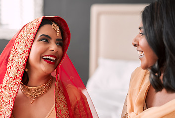 Image showing Laughing, bride and bridesmaid getting ready for a wedding, happy and helping in a room. Support, love and a young woman in traditional Indian clothes for marriage ceremony with a friend or sister