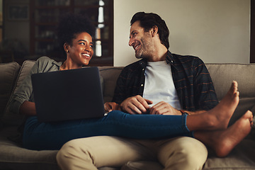 Image showing Laptop, relax and an interracial couple streaming a movie using an online subscription service for entertainment. Computer, watching or internet with a man and woman bonding together over a video