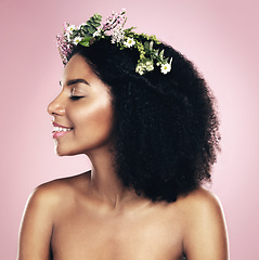 Image showing Happy woman, face and flower crown for beauty in studio, pink background and natural skincare. Smile, african model and plants for floral wreath, spring cosmetics and dermatology of afro hair care