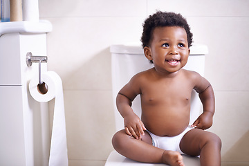 Image showing Baby boy, toilet and smile in house, learning and African childhood development with potty training. Young toddler, black child or kid sitting in bathroom with diaper, growth and happiness in home