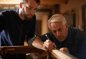 Image showing Teaching, learning and carpentry apprentice and help with pencil in designer furniture manufacturing workshop. Mentorship, carpenter and young man, wood and teamwork at sustainable business project.