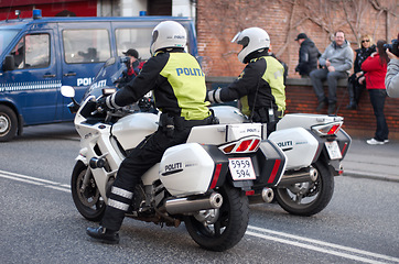 Image showing Police, law enforcement and men on motorcycle in street with transport, public servant and security in the city. Safety, male people on patrol or escort for event with policeman on transportation