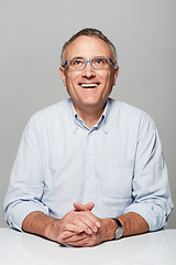 Image showing Happy, smile and mature man in a studio with a good, confident and positive mindset with glasses. Happiness, spectacles and senior male person with excited face expression isolated by gray background