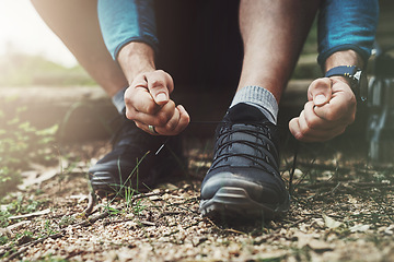 Image showing Tying laces, hiking and hands in nature to start walking, adventure or trekking for exercise. Shoes, sports and feet of a man getting ready for cardio, training or a walk for fitness in a park