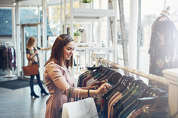 Image showing Shopping, retail and woman in a store, customer and happy with fashion, clothes and selection. Female client, lady and shopper with boutique items, sale and discount with luxury product and decision