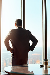 Image showing Building window, business man and thinking of ideas, plan or vision with cityscape. Professional male executive with hands on hips for inspiration, dream and corporate development from behind