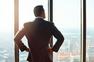 Image showing Business man, building and window for thinking of ideas, future plan or vision by cityscape. Professional male executive with hands on hips for inspiration, dream or corporate development from behind